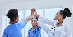 Group of female nurses high fiving each other