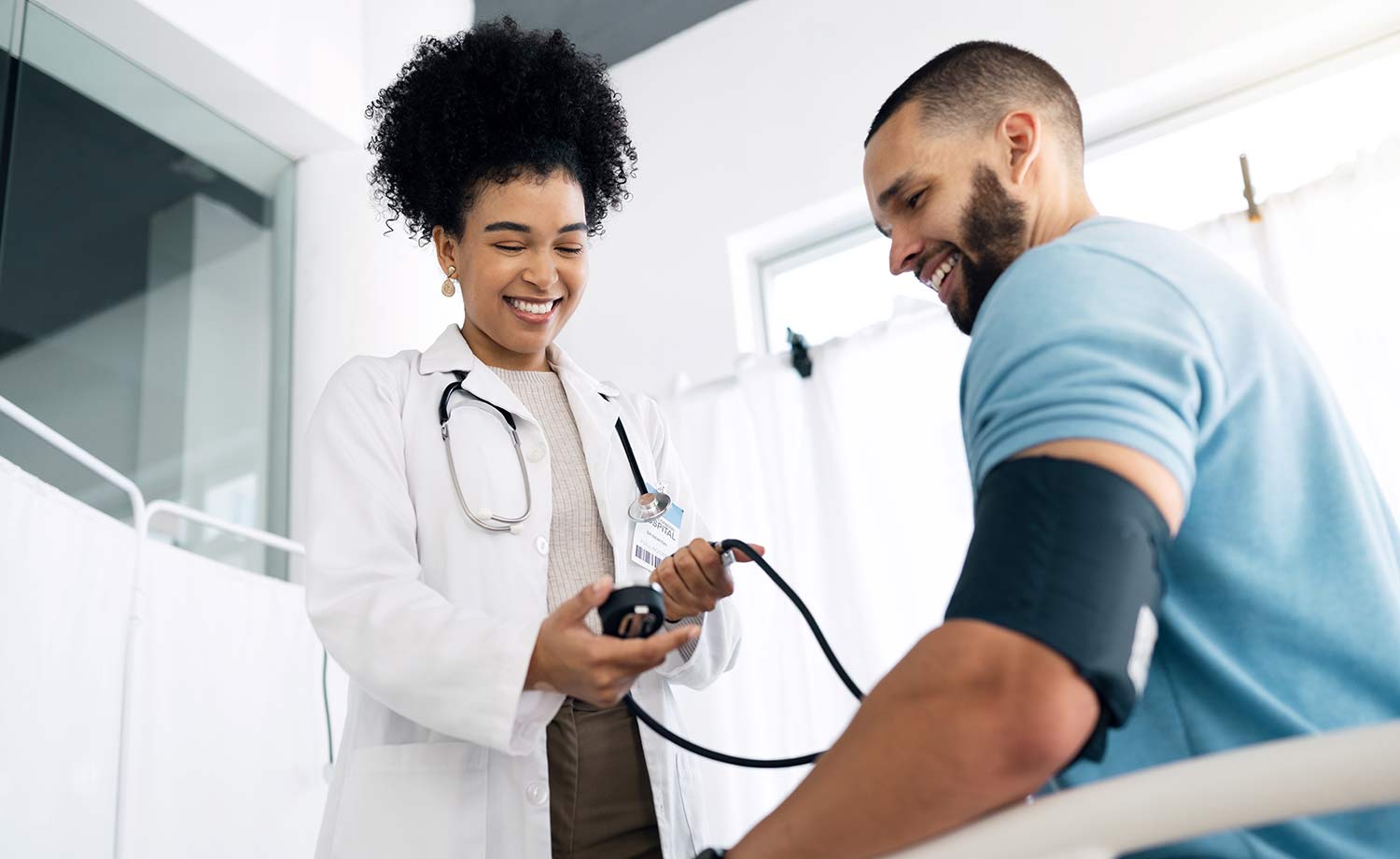 African-American medical professional taking a man's blood pressure